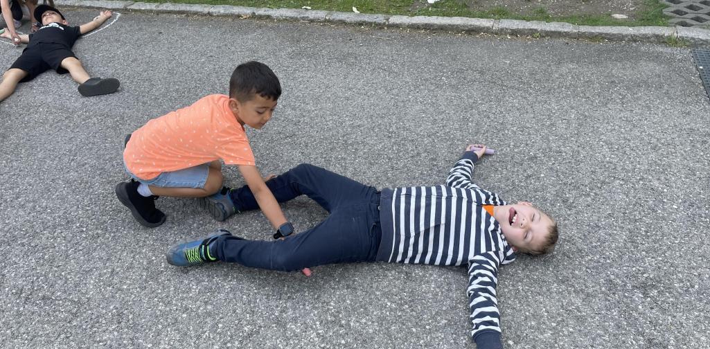 Kinder malen mit Straßenkreiden Figuren