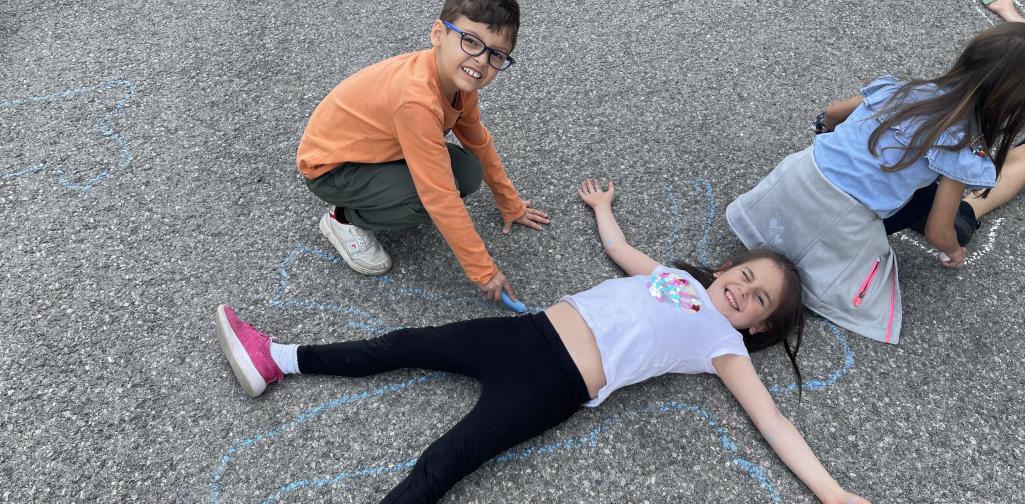 Kinder malen mit Straßenkreiden Figuren