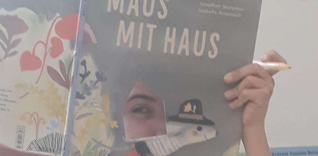 Vorlesetag 2 Kind schaut durch ein Loch im Buchdeckel